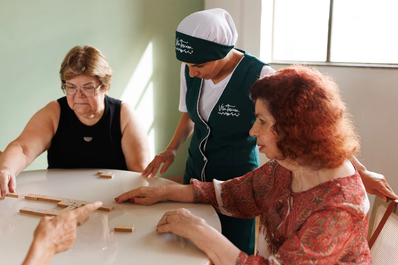 Profissional do Grupo Villa ao lado de uma moradora
